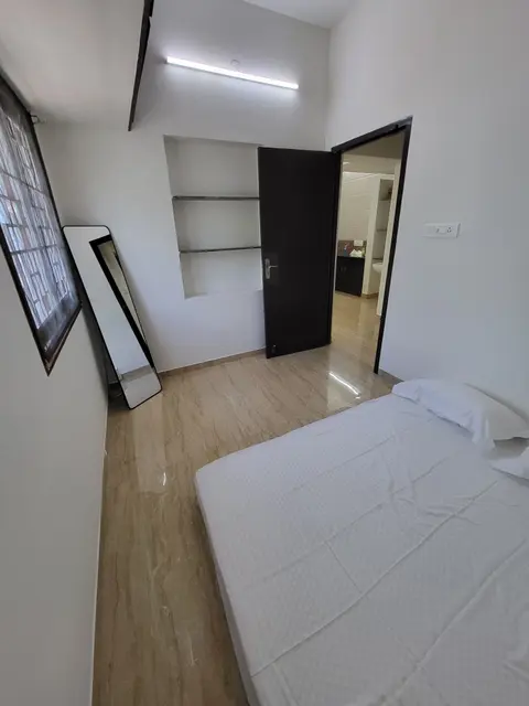 Second bedroom with a floor mattress and the open door to the hall